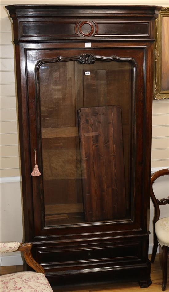 A mid 19th century French rosewood bookcase, enclosed by a single glazed door, H.216cm W.106cm W: 108cm